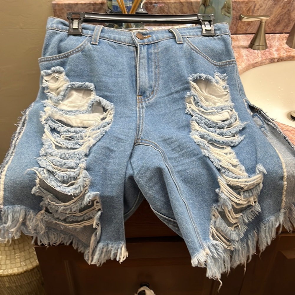 Blue cut up above knee short with both sides open . Very cute worn only once.